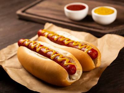 Hot dog with ketchup and yellow mustard.