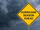 Ominous clouds with sign "Hurricane Season Ahead"