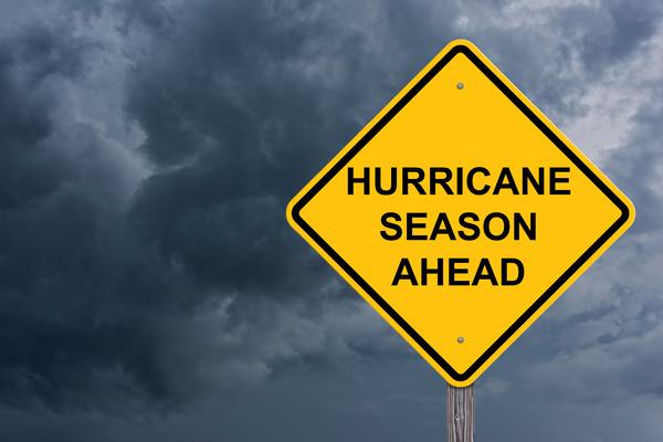 Ominous clouds with sign "Hurricane Season Ahead"
