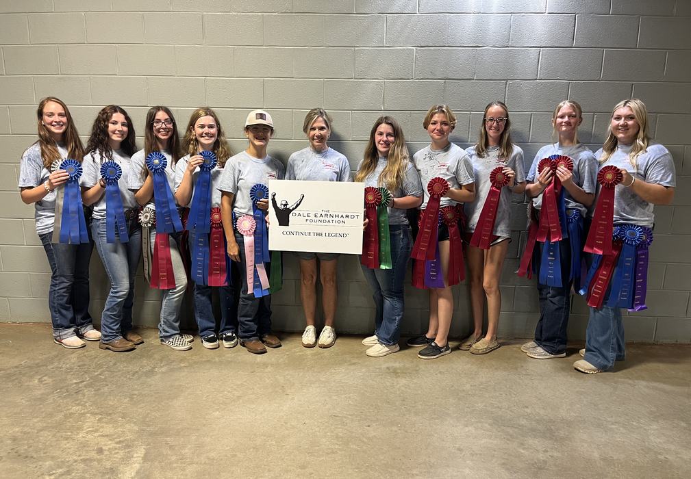 Twelve people holding award ribbons and sign: "The Dale Earnhardt Foundation – Continue the Legend"