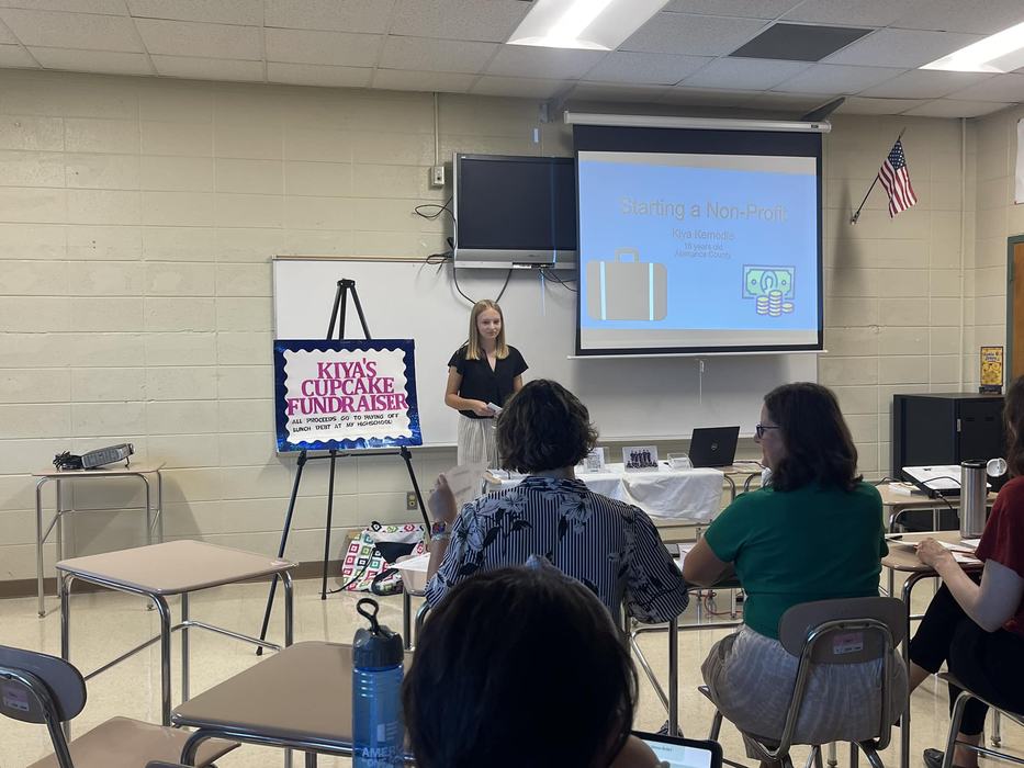 A girl gives a presentation on a cupcake fundraiser and Starting a Non-Profit.