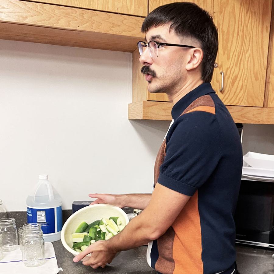 Close-up image of a cucumber with a small section being cut off.