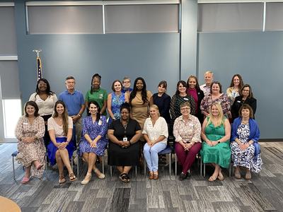 Group of men and women posing for a group photo.