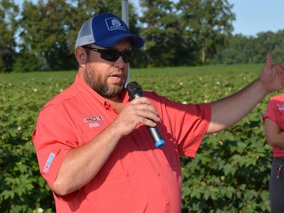 Man in Red shirt holding a microphone.
