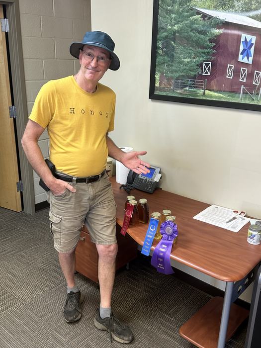 Beekeeper with honey and ribbons