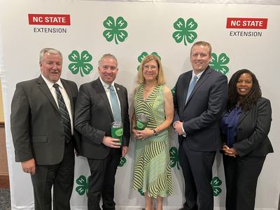 Orange County 4-H Staff Smith and Rogers receiving award from NCAE4-HYDP in Concord in August 2024