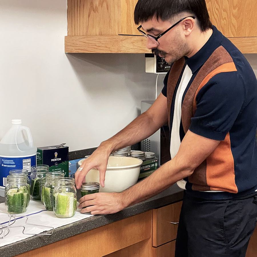 Adjusting lids on canning jars, following manufacturer’s instructions.