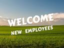 Green field under blue sky with large white text "WELCOME NEW EMPLOYEES"