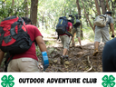 Hikers with backpacks climbing a forest trail; text: OUTDOOR ADVENTURE CLUB with 4‑H logos