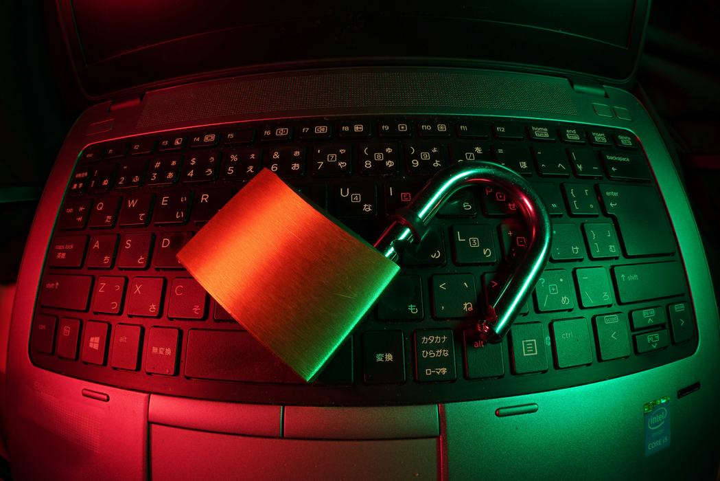 An unlocked padlock on a laptop. 