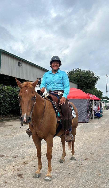 A young woman rides a horse on the state fairgrounds.