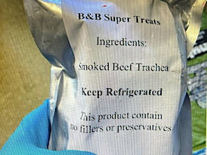 gloved hand holding foil package of B&B Super treats