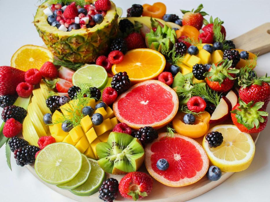 a plate full of mixed fruits and vegetables