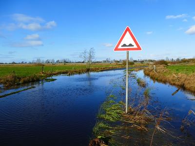 flooded ground with a warning sign