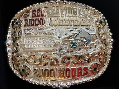 Ornate silver belt buckle reading "RECREATIONAL RIDING ACHIEVEMENT" and "2000 HOURS"