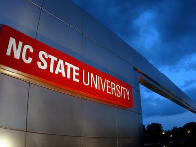 The NC State University gateway arch sign welcomes everyone to campus along Western Blvd. in Raleigh.