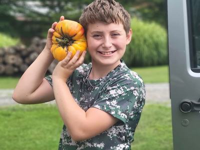 Tomato Contest WInner with his winning tomato