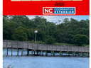 Red banner reading "EXPLORE" and NC Cooperative Extension above a wooden dock over water