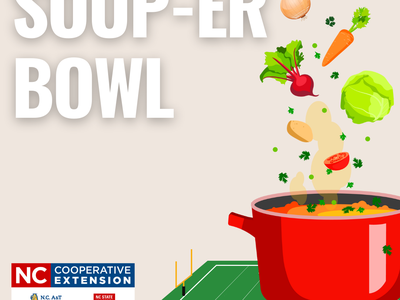Soup-er Bowl text over image of red soup pot with food ingredients above sitting on a football field