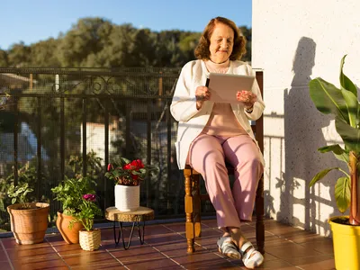 person with an iPad outdoors