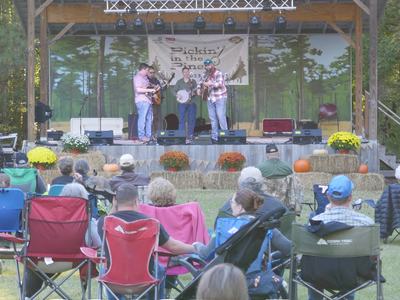 group on lawn watching bluegrass band