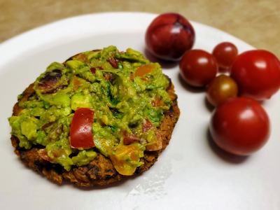 sweet potato burger on plate with side of tomatoes