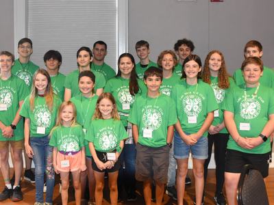 Group of children and teens wearing green Lab Rats 4‑H Club shirts and name tags, posed