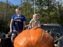 Two 4-H youth with their giant pumpkin