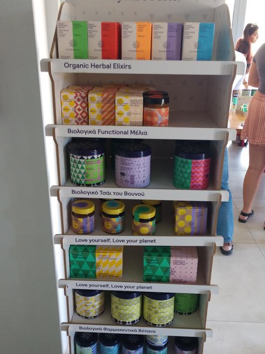 Shelf with colorful jars and boxes labeled "Organic Herbal Elixirs" and "Love your planet"