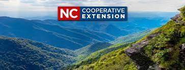 Mountain ridge and trail with "NC Cooperative Extension" logo