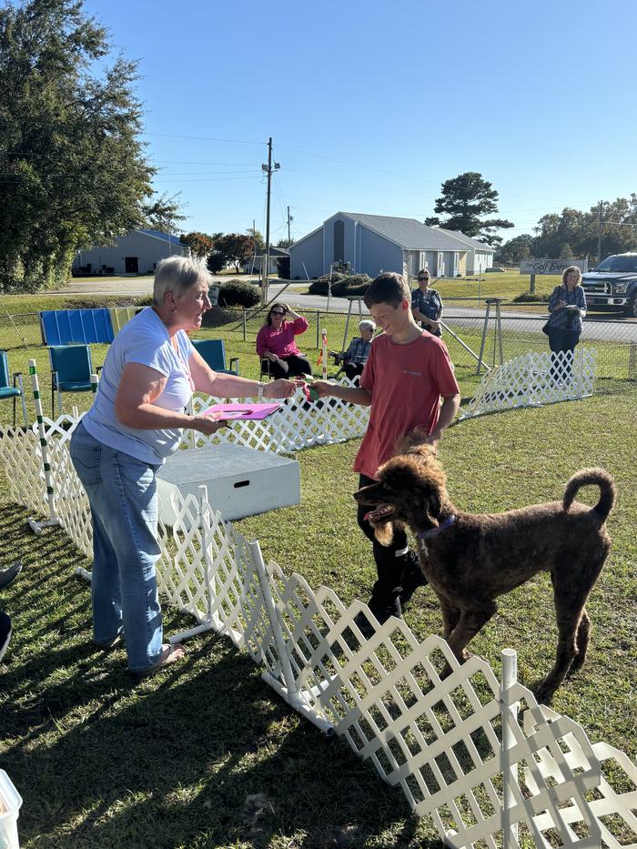 Lando, handled by Collin Lewis, receiving his 2nd place ribbon