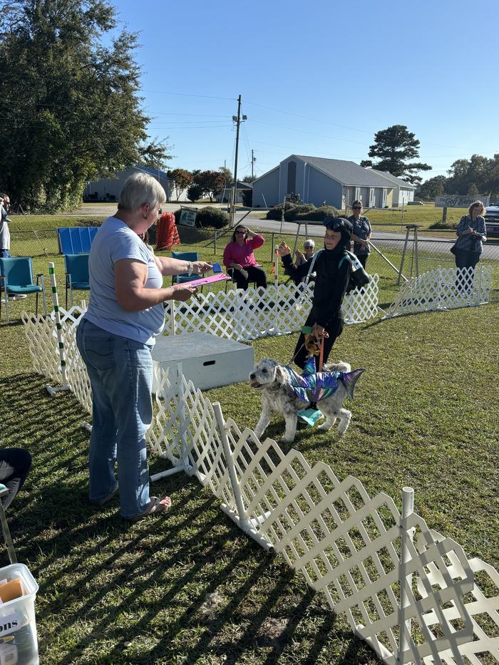Carter Becton and his canine companion, Gilbert receiving their 1st place ribbon