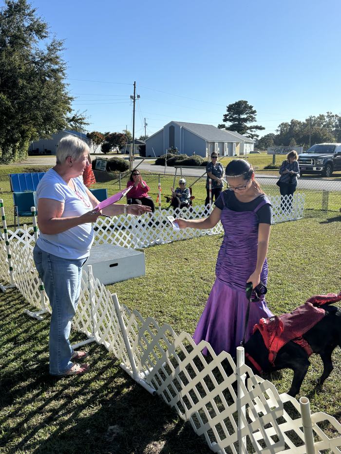 Catherine Paschall and her canine companion, Mei receiving their 3rd place ribbon