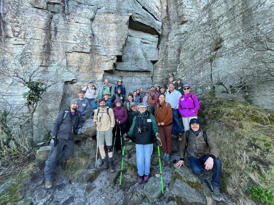 Class of students beside a mountain