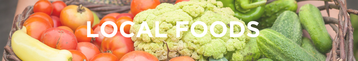 Basket of tomatoes, cauliflower, cucumbers with overlaid text "LOCAL FOODS"