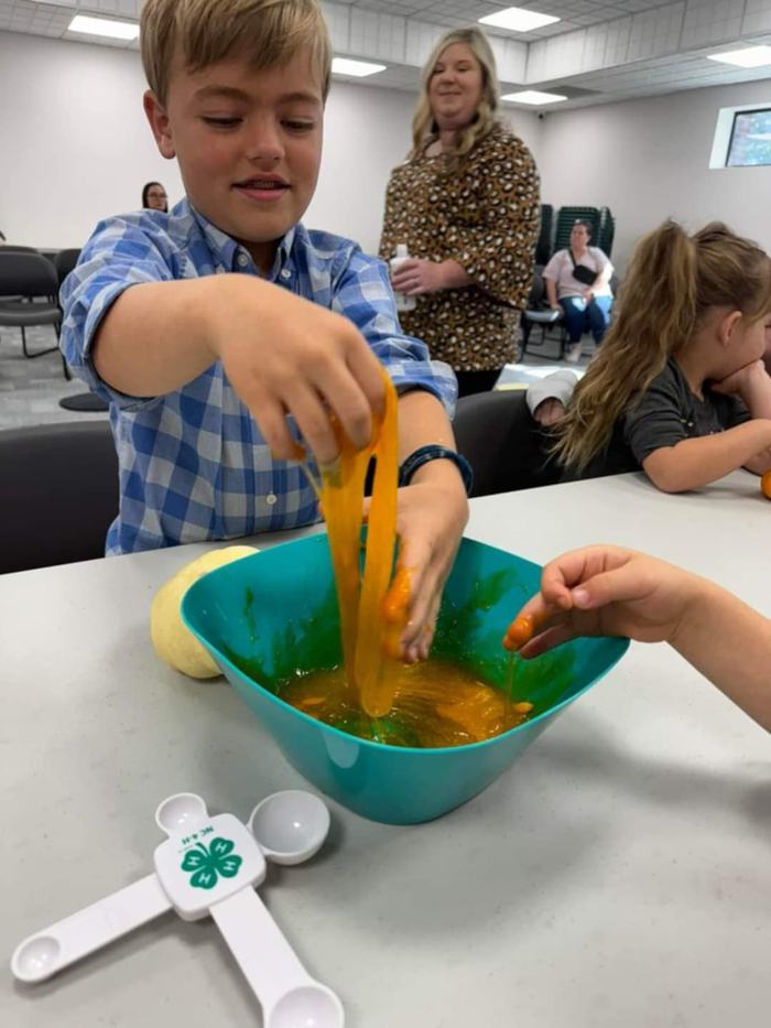 Students work with orange slime.