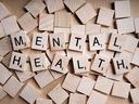 wooden tile letters spelling mental health