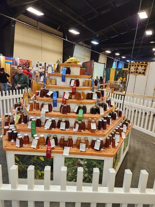 A display of honey at a fair.