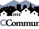 Mountain silhouette and neighborhood skyline above the text "WNC Communities"