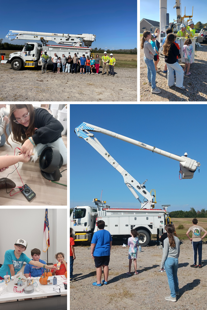 Children and workers standing near a utility bucket truck during outdoor safety demo