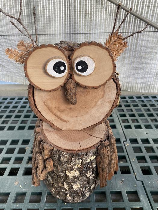 An Owl made of logs and bark.
