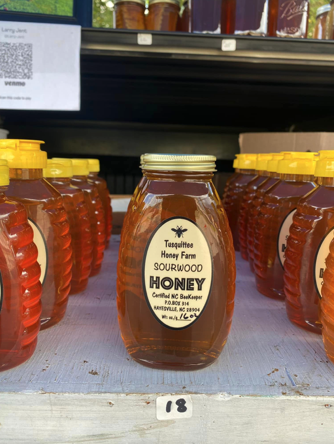 Jar of Tusquittee Honey Farm Sourwood Honey on shelf with label and shelf tag "18"