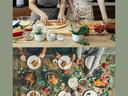 Two people cooking in a kitchen and a table with meal spread on it with people eating meal