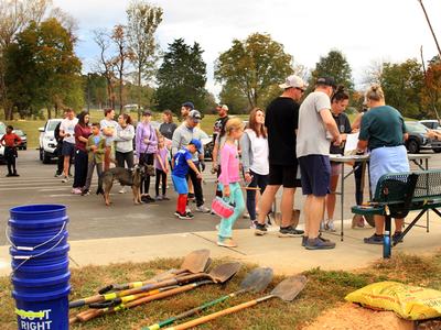 Volunteers standing in line waiting to plant trees