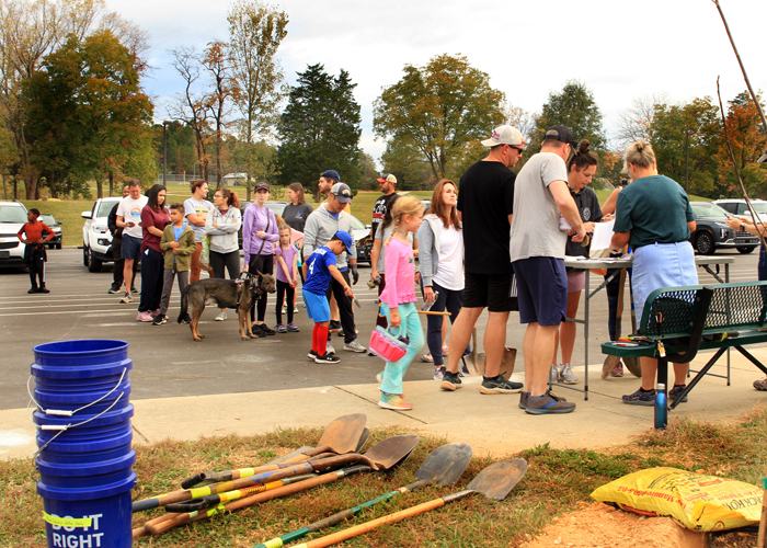 Volunteers standing in line waiting to plant trees