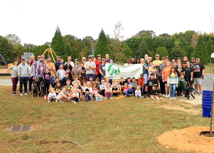 Group photo of volunteers who helped plant trees at local elementary school