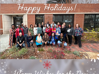 Durham Cooperative Extension staff posing outside; text: "Happy Holidays"