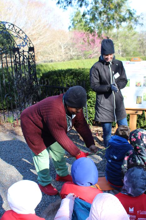 Instructor showing students a plant