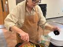 participant stirring a dish full of vegeatbles