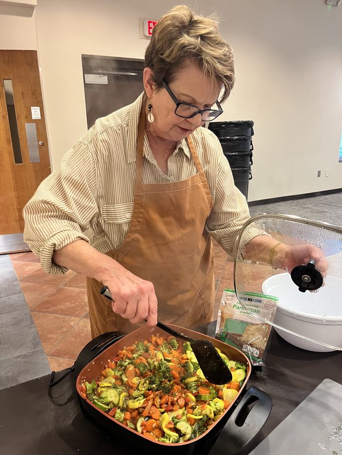 participant stirring a dish full of vegeatbles
